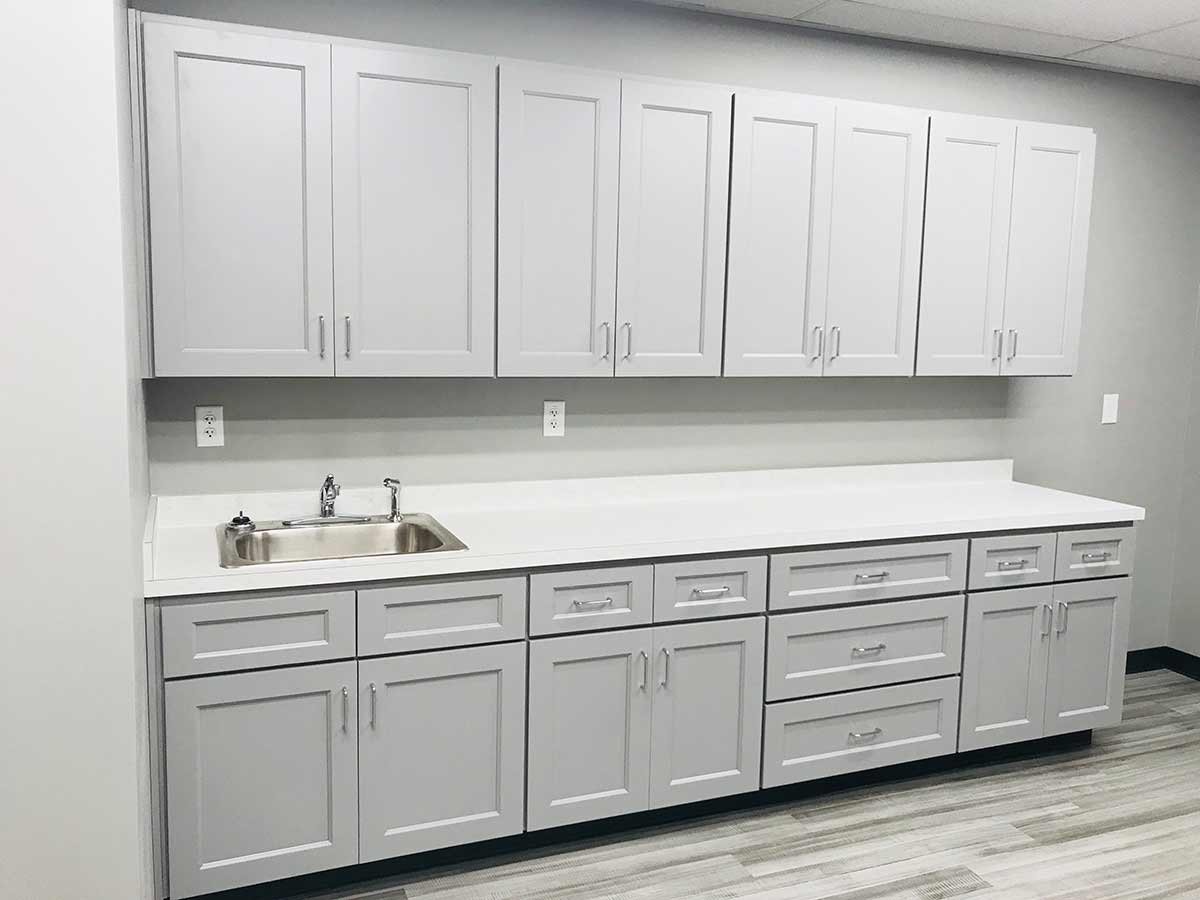 Charleston cabinet replacement — beige worn-out cabinets to light grey shaker — after